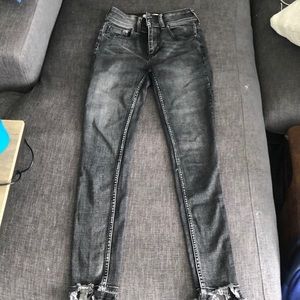 Black skinny We the Free jeans with frayed bottom.